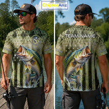 Load image into Gallery viewer, Man wearing a Bass fishing-themed t-shirt with a large mouth bass graphic, outdoors by water.