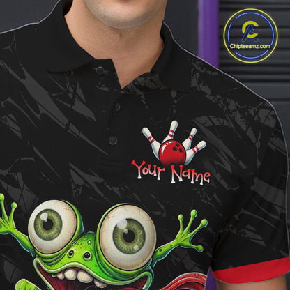 A close-up of a man wearing a black short-sleeve polo shirt with a bowling-themed graphic. The shirt features a green cartoon frog with large eyes and a red bowling ball and pins design above the text 'Your Name' with a placeholder name.