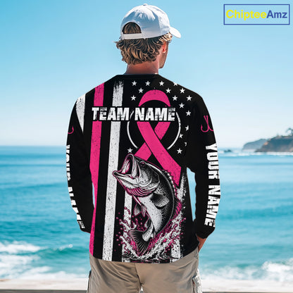 A man stands on a beach facing the ocean, wearing a black long-sleeve graphic shirt with a pink ribbon, fish illustration, and customizable text. A 'ChijiseeAmz' watermark is visible in the top right corner.
