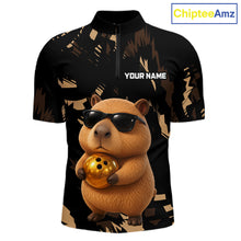 Load image into Gallery viewer, Black polo shirt with a capybara holding a gold ball design and 'Your Name' text, brand 'ChipteeAmz' visible.