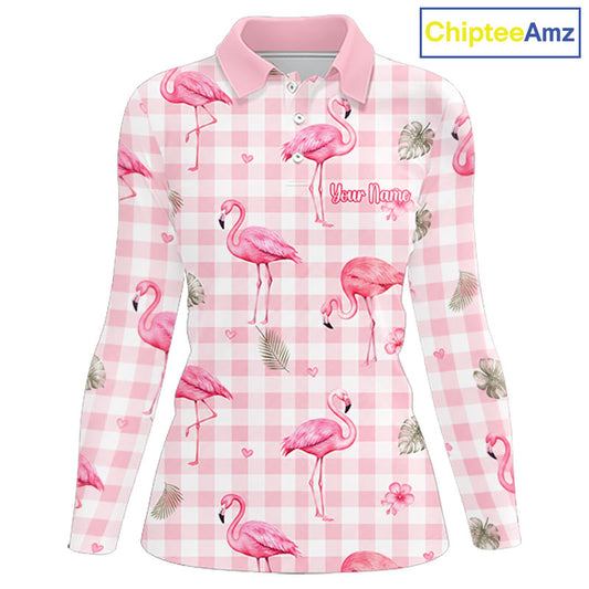 A long-sleeve women's polo shirt with a pink and white gingham pattern, decorated with pink flamingos, palm leaves, and small hearts. The shirt features a pink collar and a customizable text placeholder 'Your Name' printed on the chest.