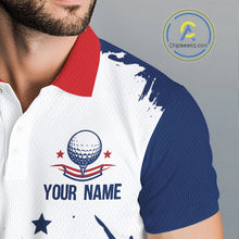 Load image into Gallery viewer, Close-up of American flag patriotic graphic on mens white golf polo shirt with golf ball logo and custom name on the chest