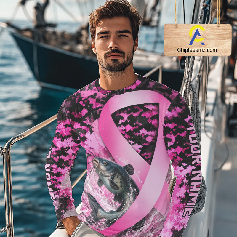 Angler wearing pink ribbon camouflage catfish fishing breast cancer long sleeve sun protection shirt on the water