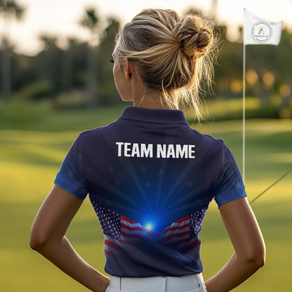 Woman on a golf course wearing a blue polo shirt with 'TEAM NAME' on the back.