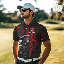 Load image into Gallery viewer, Golfer wearing custom black and red American flag skull reaper golf polo shirt on the course - front view