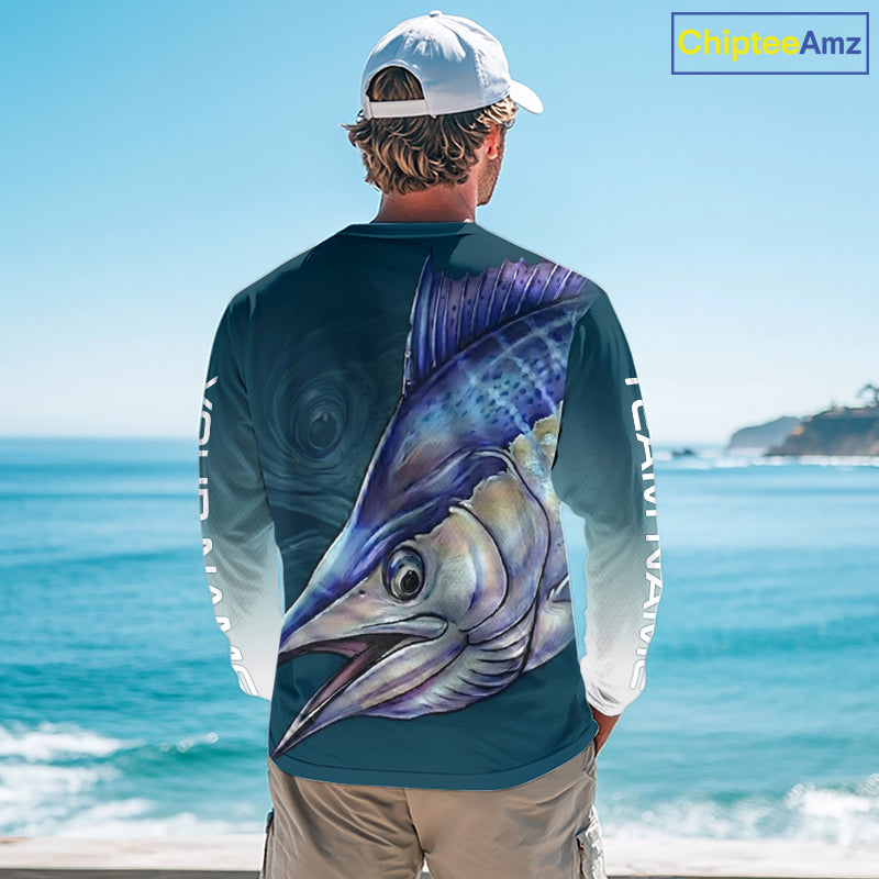Angler wearing patriotic American Flag Marlin long sleeve fishing shirt on boat.