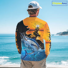 Load image into Gallery viewer, Person wearing a saltwater fishing-themed long sleeve fishing shirt with a sunset and fish reaper design, standing on a boat.