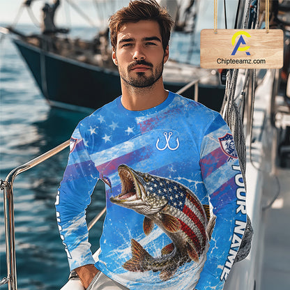 Man wearing a blue patriotic northern pike fishing shirt with custom name, standing on a boat