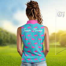 Load image into Gallery viewer, Woman wearing a turquoise sleeveless polo shirt with pink flamingo pattern and 'Team Name' text on the back, standing on a golf course.