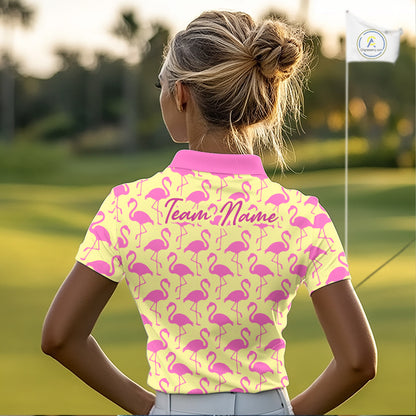 Woman wearing a yellow polo shirt with pink flamingo pattern and 'Team Name' text on the back, standing on a golf course.