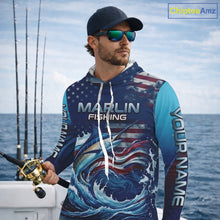 Load image into Gallery viewer, Angler wearing Personalized American Flag Marlin Fishing Shirt Patriotic Marlin Long Sleeve Hooded Shirt, breathable UPF 30+ long sleeve hooded fishing shirt on the boat
