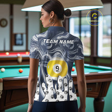 Load image into Gallery viewer, Back view of woman wearing a blue marble swirl 8 ball and 9 ball pool shirt in a billiards hall.