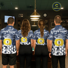 Load image into Gallery viewer, Back view of pool players wearing matching blue marble swirl billiard shirts in a game room.