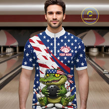 Load image into Gallery viewer, Man wearing a bowling shirt with American flag design and a green alligator holding a bowling ball in a bowling alley.