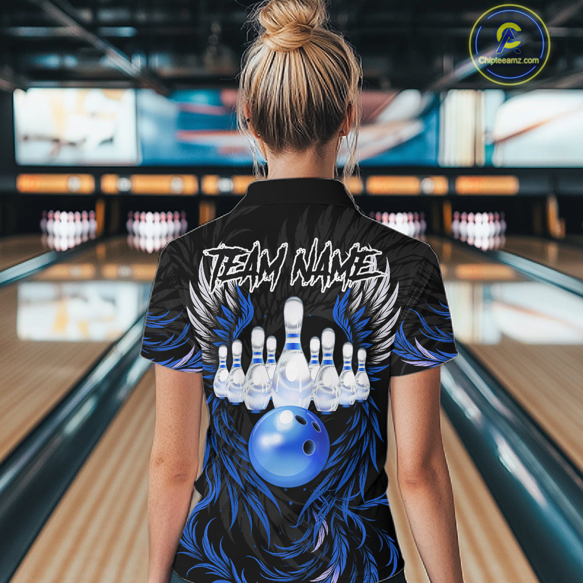 Woman wearing black and blue phoenix wings bowling polo shirt back view.
