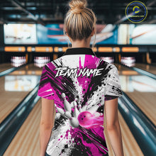 Load image into Gallery viewer, Back view of woman wearing a pink splatter bowling polo shirt inside a bowling alley.