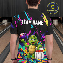 Load image into Gallery viewer, Person wearing a black bowling shirt with colorful design and turtle graphic in a bowling alley.