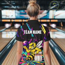 Load image into Gallery viewer, Person wearing a colorful bowling-themed shirt with a bee design in a bowling alley.