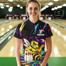 Load image into Gallery viewer, Person wearing a black bowling shirt with colorful design and bee graphic in a bowling alley.