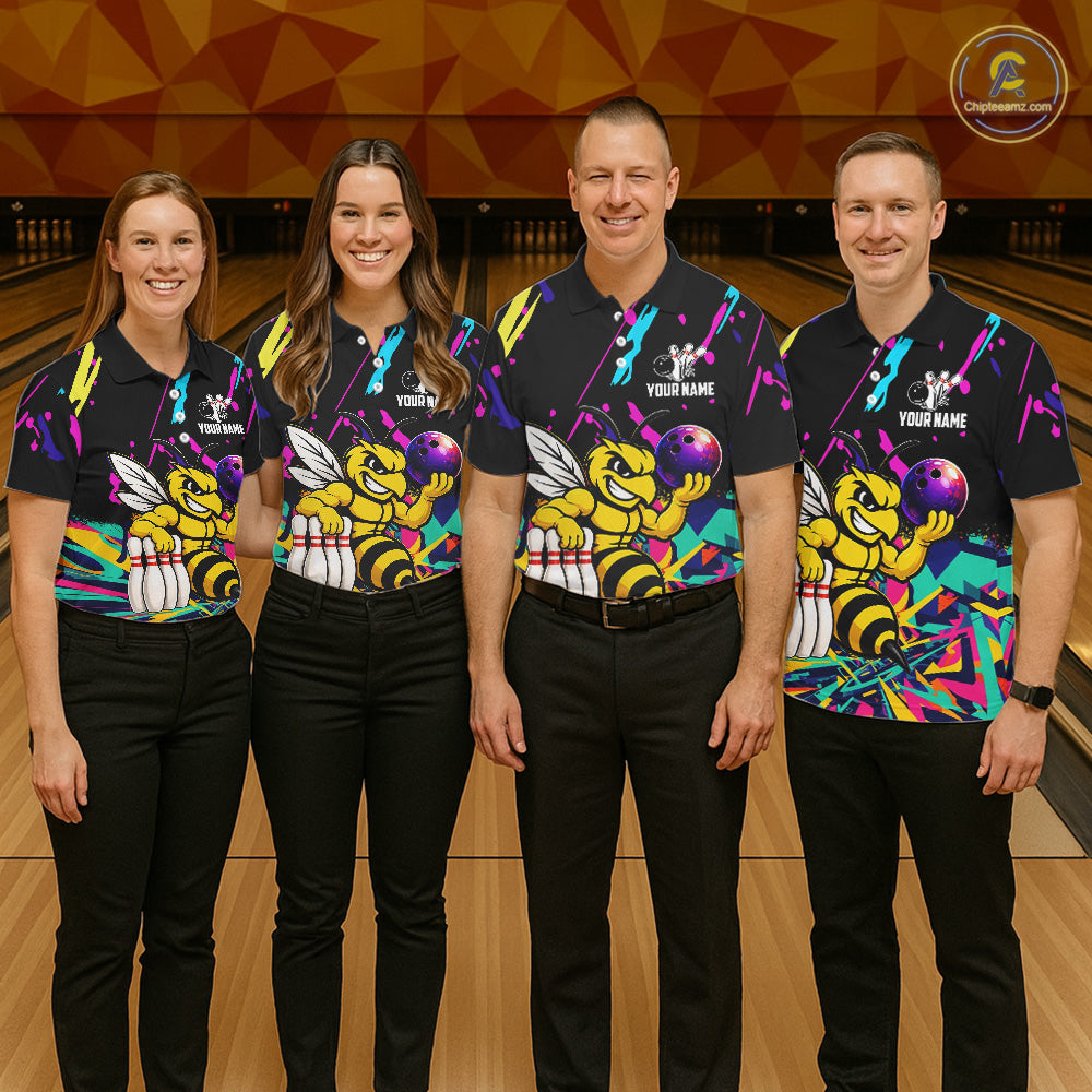 Four people wearing matching bowling-themed shirts with bee graphic in a bowling alley.