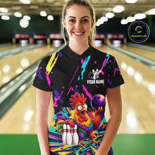 Load image into Gallery viewer, Person wearing a black bowling shirt with colorful design and chicken graphic in a bowling alley.