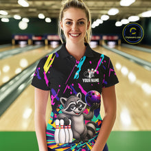 Load image into Gallery viewer, Woman wearing a colorful bowling-themed shirt with a raccoon graphic in a bowling alley.