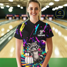 Load image into Gallery viewer, Person wearing a black bowling shirt with colorful design and raccoon graphic in a bowling alley.