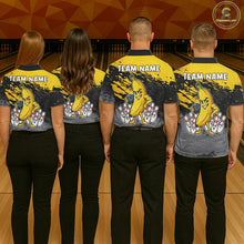 Load image into Gallery viewer, Back view of bowling team wearing matching yellow banana bowling shirts in a bowling alley.