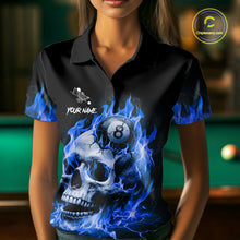 Load image into Gallery viewer, Woman wearing a blue flaming skull 8 ball and 9 ball billiard jersey beside a pool table front view.
