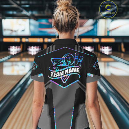 Back view of woman wearing a holographic bowling polo shirt inside a bowling alley.